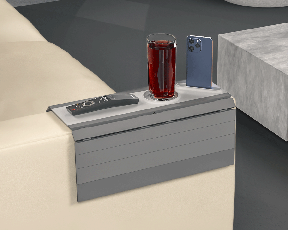 Quick Rest Modular Sofa Side Table — the grey tray on a light sofa arm holding a drink, a phone and a remote.