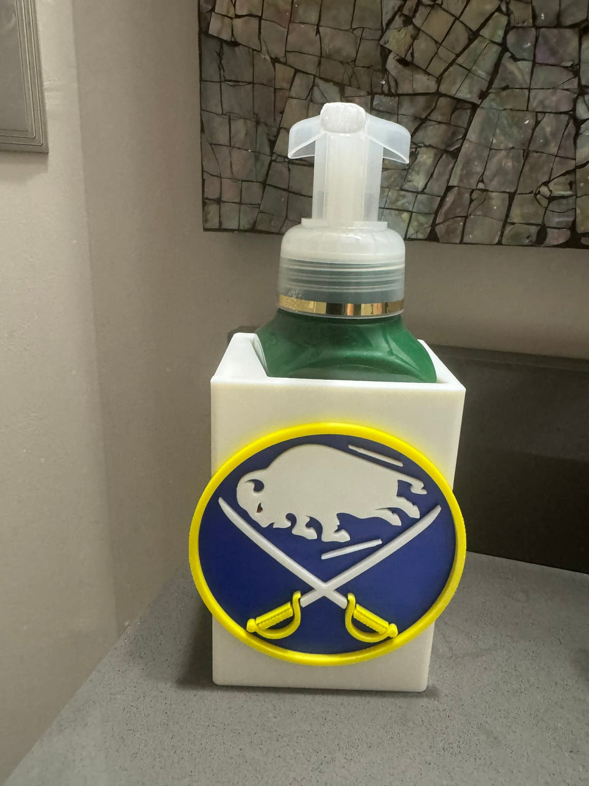 Buffalo Hockey Soap Dispenser Holder — a blue and gold sleeve-style holder with a raised front emblem, sized for a foaming soap bottle.