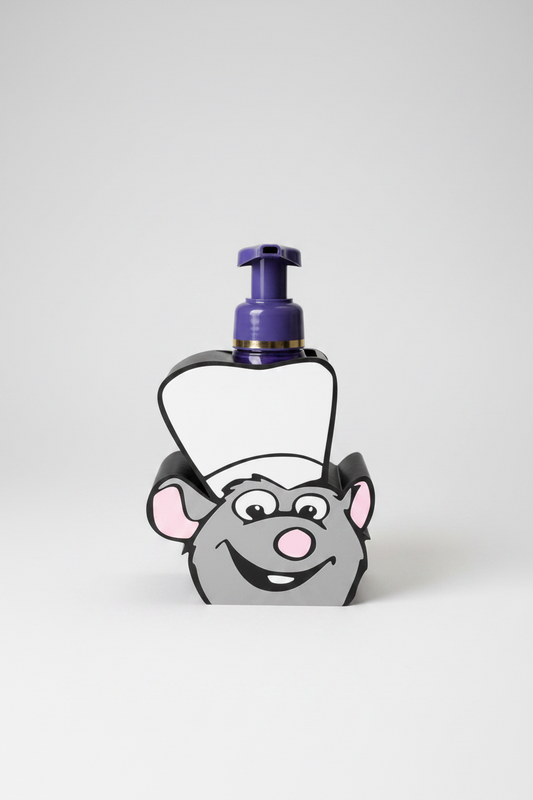 Chef Mouse Soap Dispenser Holder — a grey rounded holder in a white chef's hat, cradling a bottle with a purple pump and gold band, on a soft light-gray studio background.