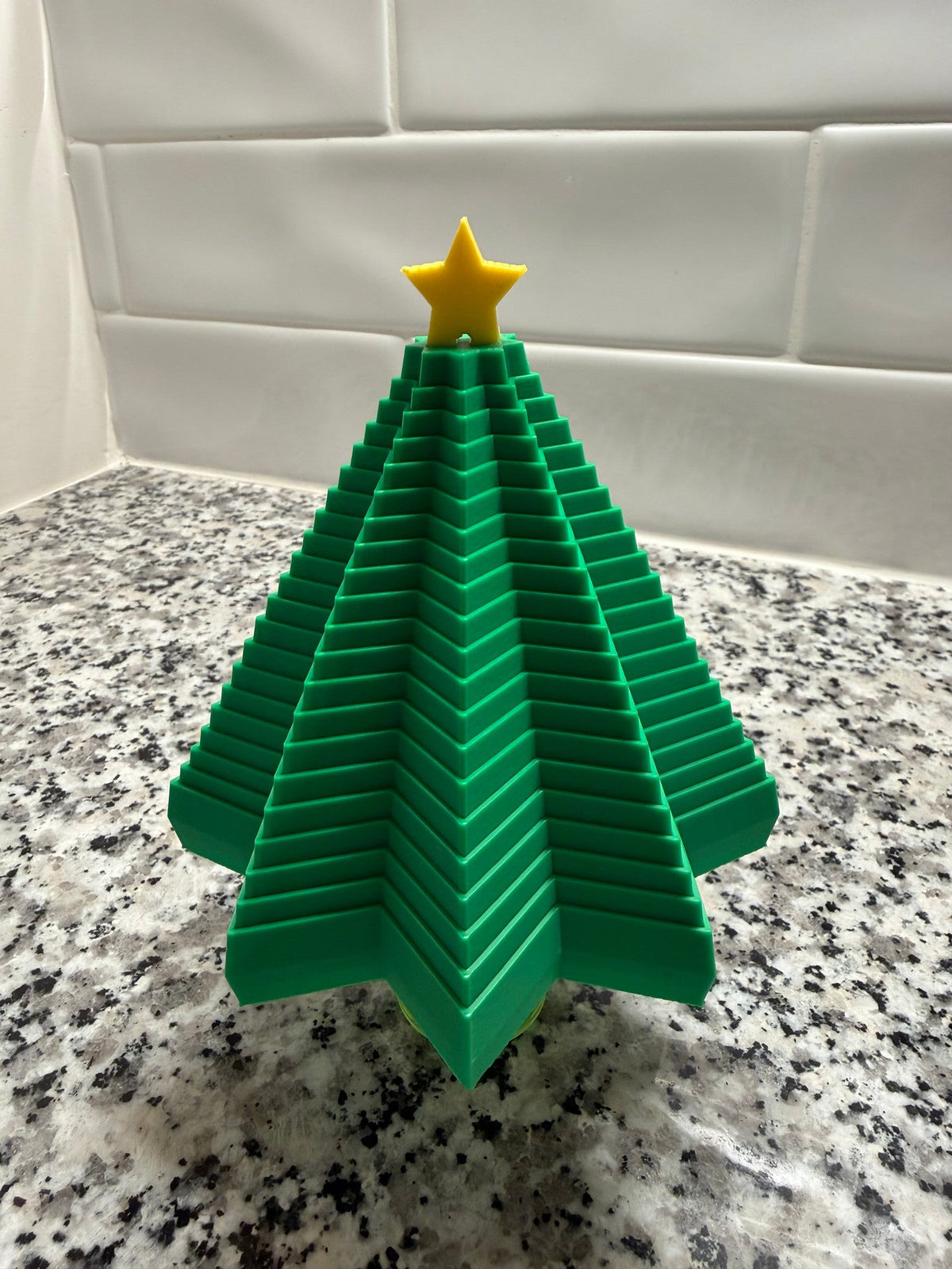 Christmas Tree Expanding Fidget — the green layered tree stood upright with a yellow star on top.