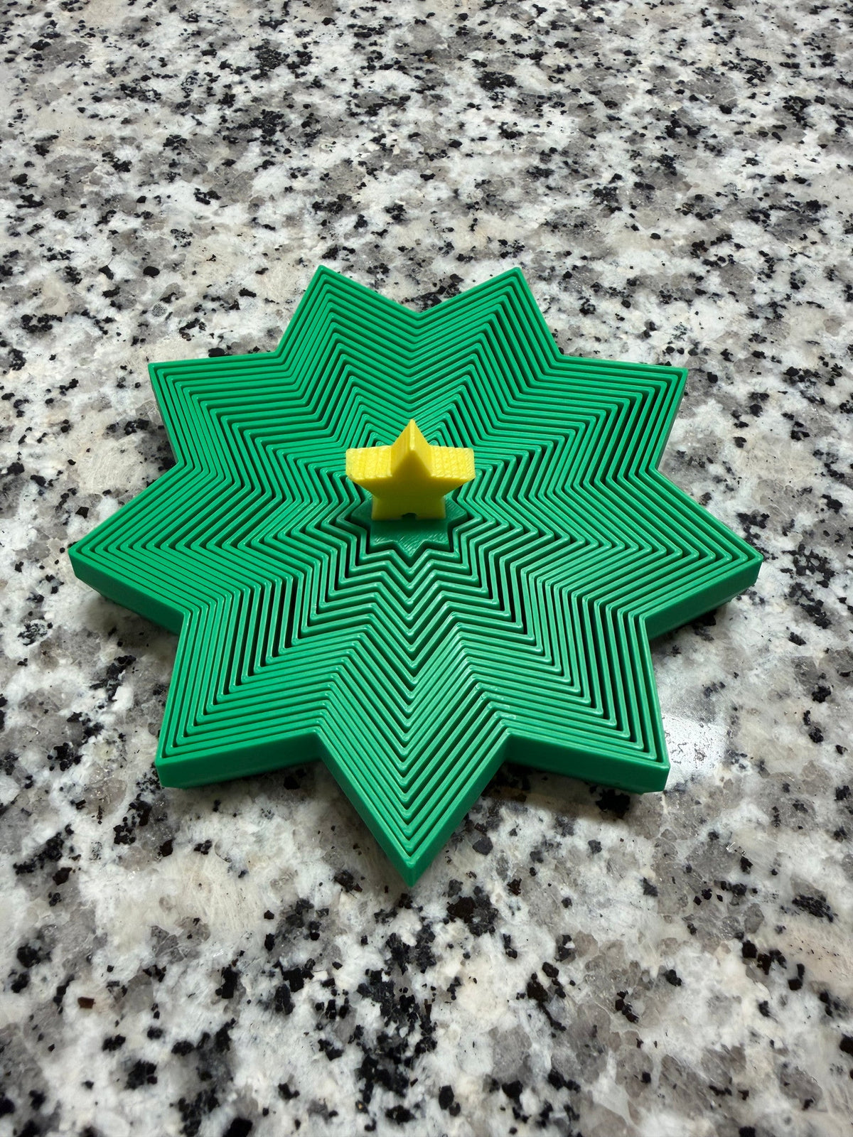 Christmas Tree Expanding Fidget — the same tree collapsed flat into a layered star shape.