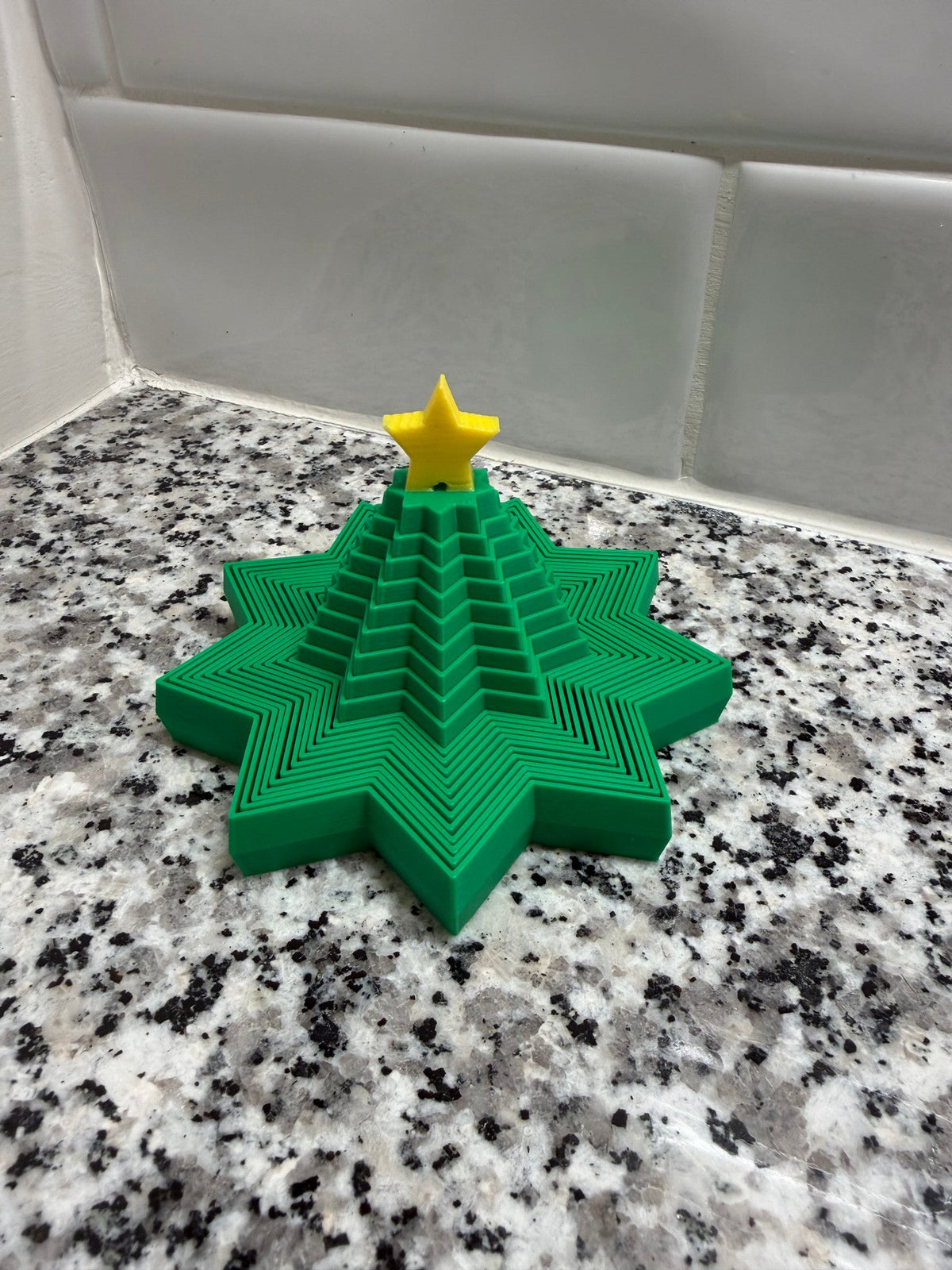 Christmas Tree Expanding Fidget — the tree part-collapsed, midway between cone and flat star.