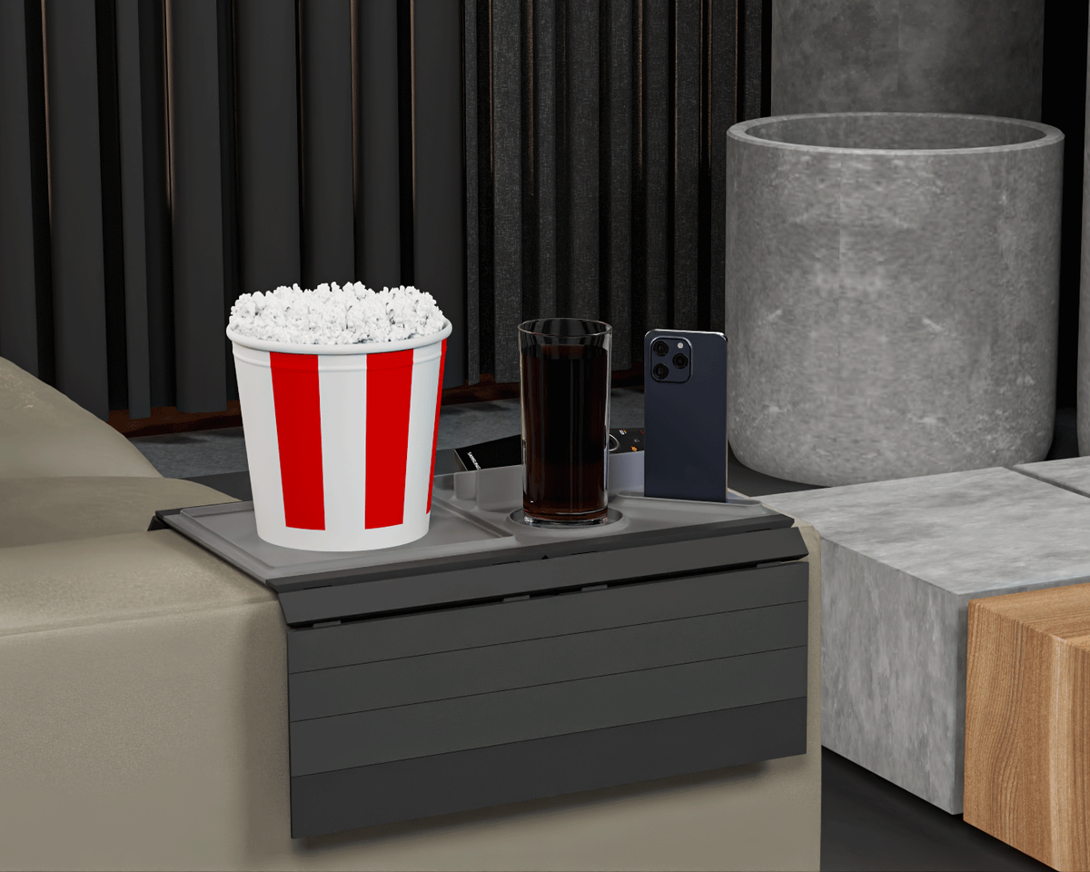 Couch Buster — Modular Sofa Side Table — the tray seen from the front of the sofa, holding popcorn, a drink and a phone.