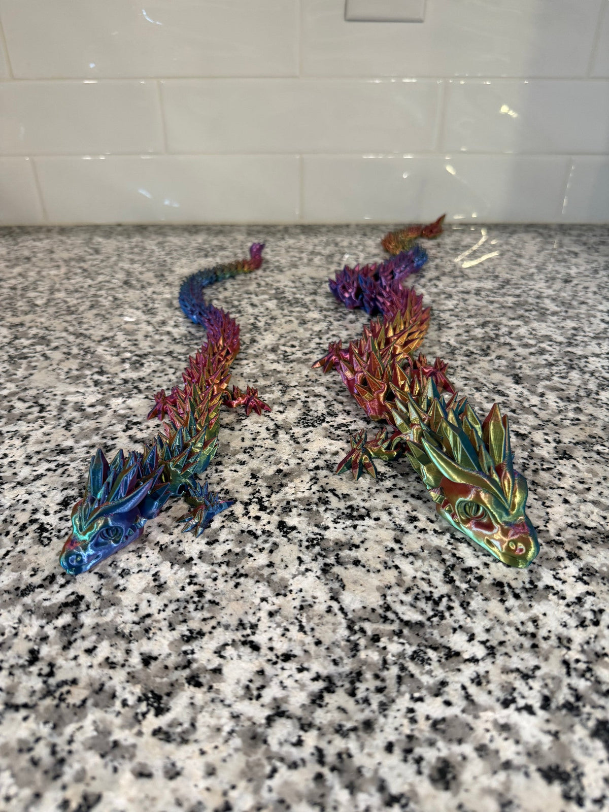 Crystal Dragon — three articulated dragons in blue, red and green, heads toward the camera.