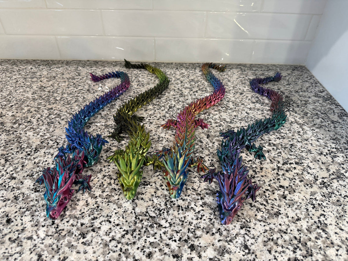 Crystal Dragon — four articulated dragons in pink, green, orange and purple fanned out side by side.