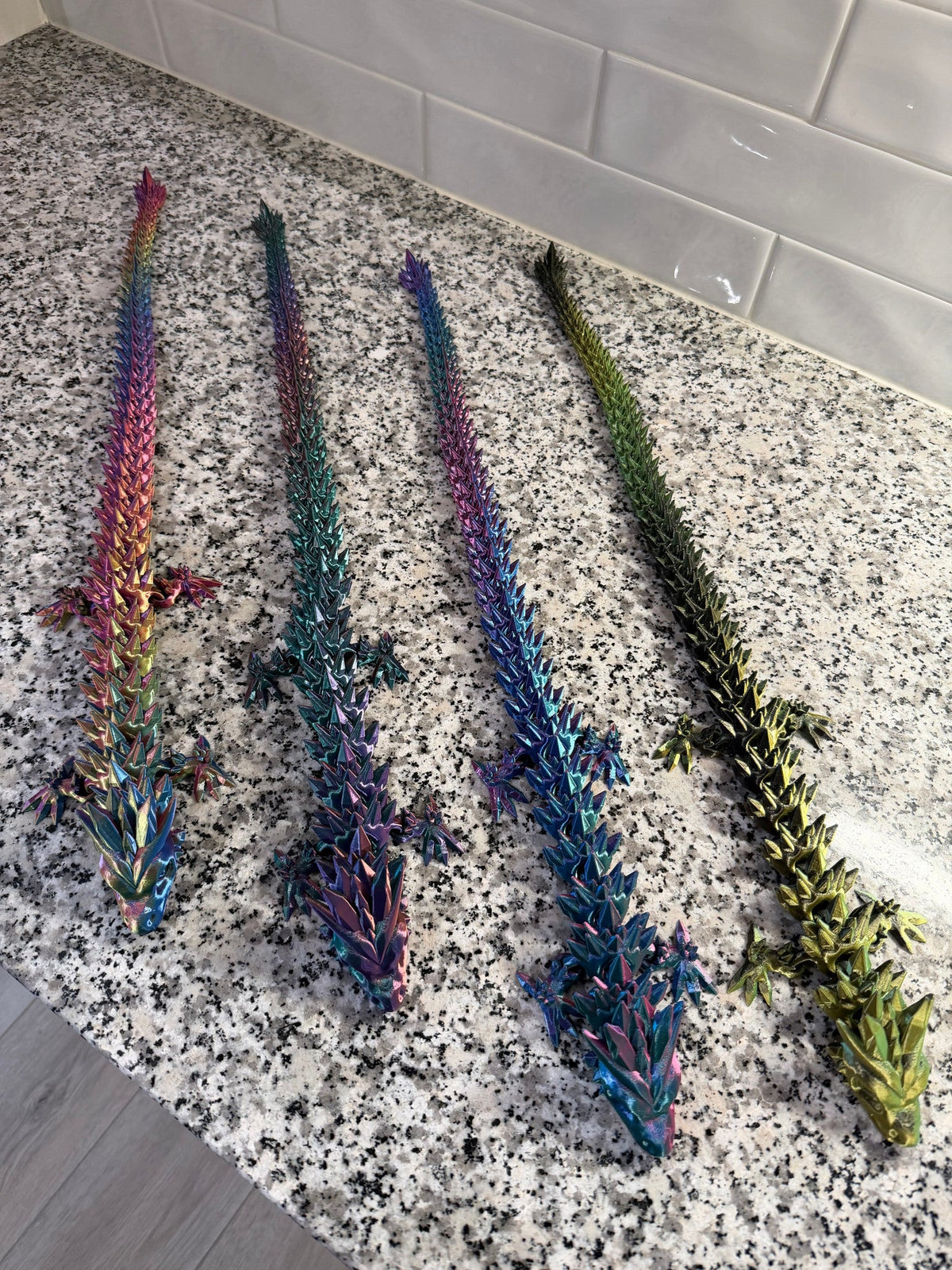Crystal Dragon — four dragons laid out diagonally, showing the full length of the jointed tails.