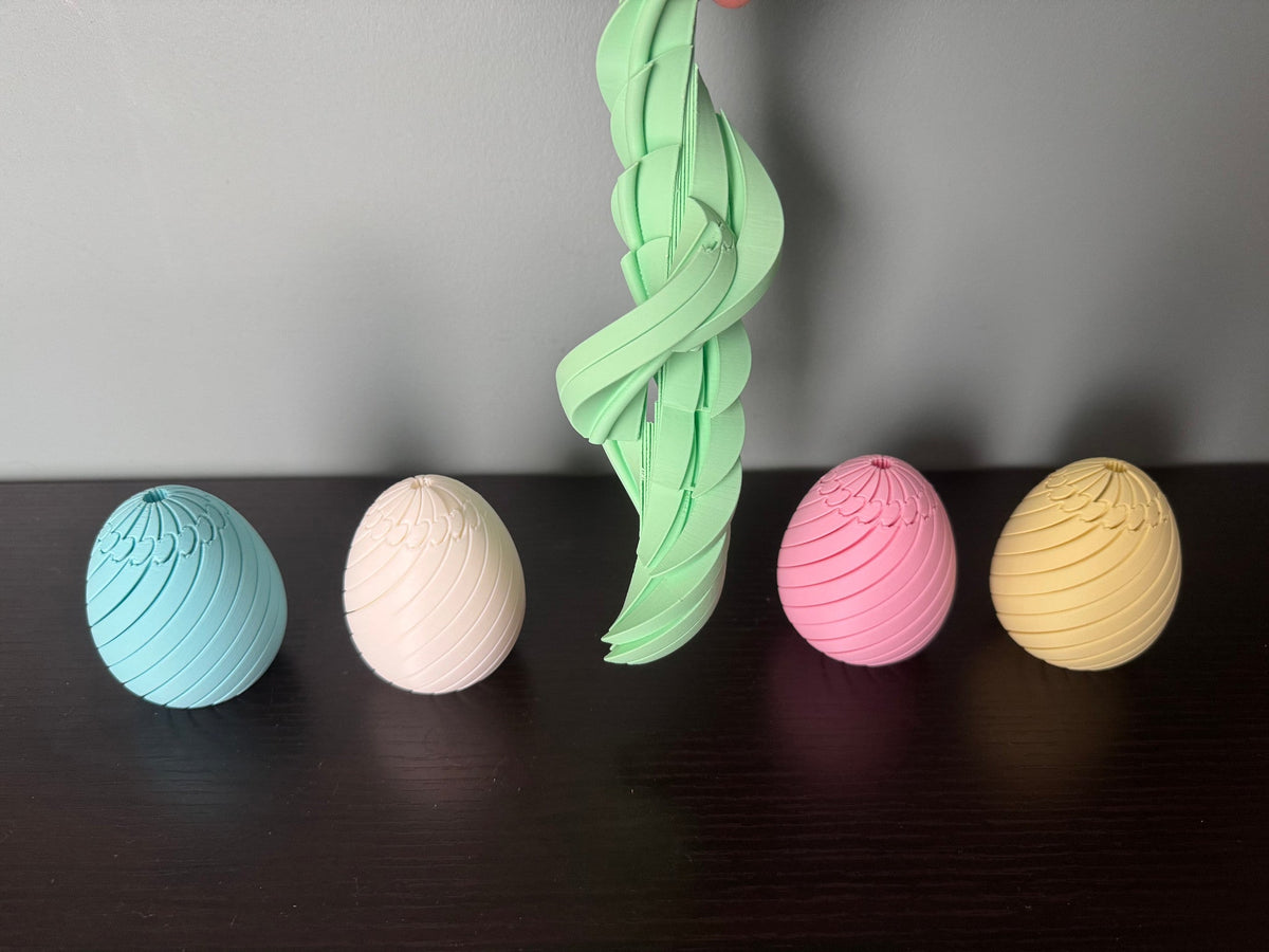 Easter Egg Spiral Fidgets — one green egg drawn open into a tall twisting spiral, beside four closed eggs.
