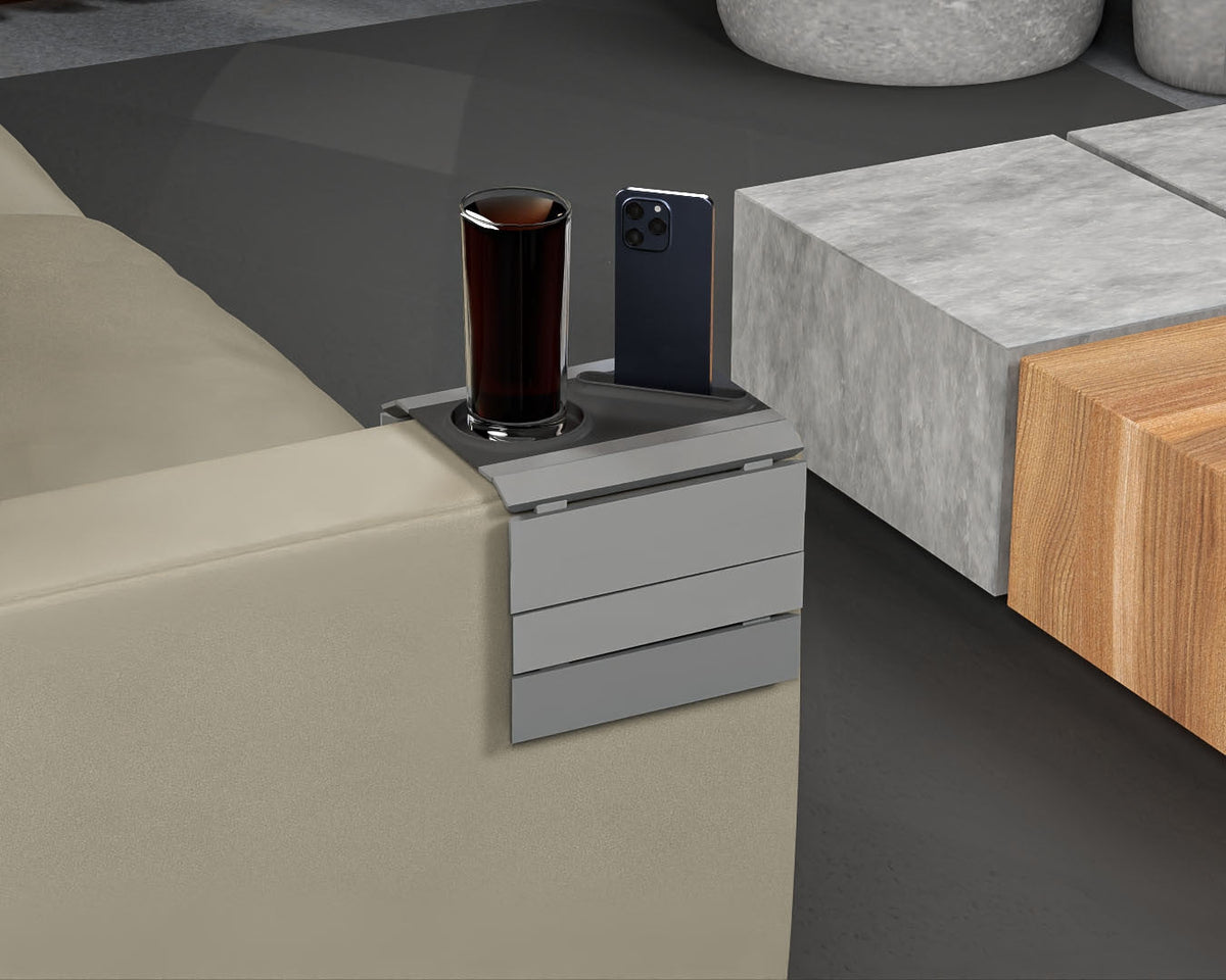 First Stop — Modular Sofa Side Table — the compact grey tray on a sofa arm holding one drink and an upright phone.