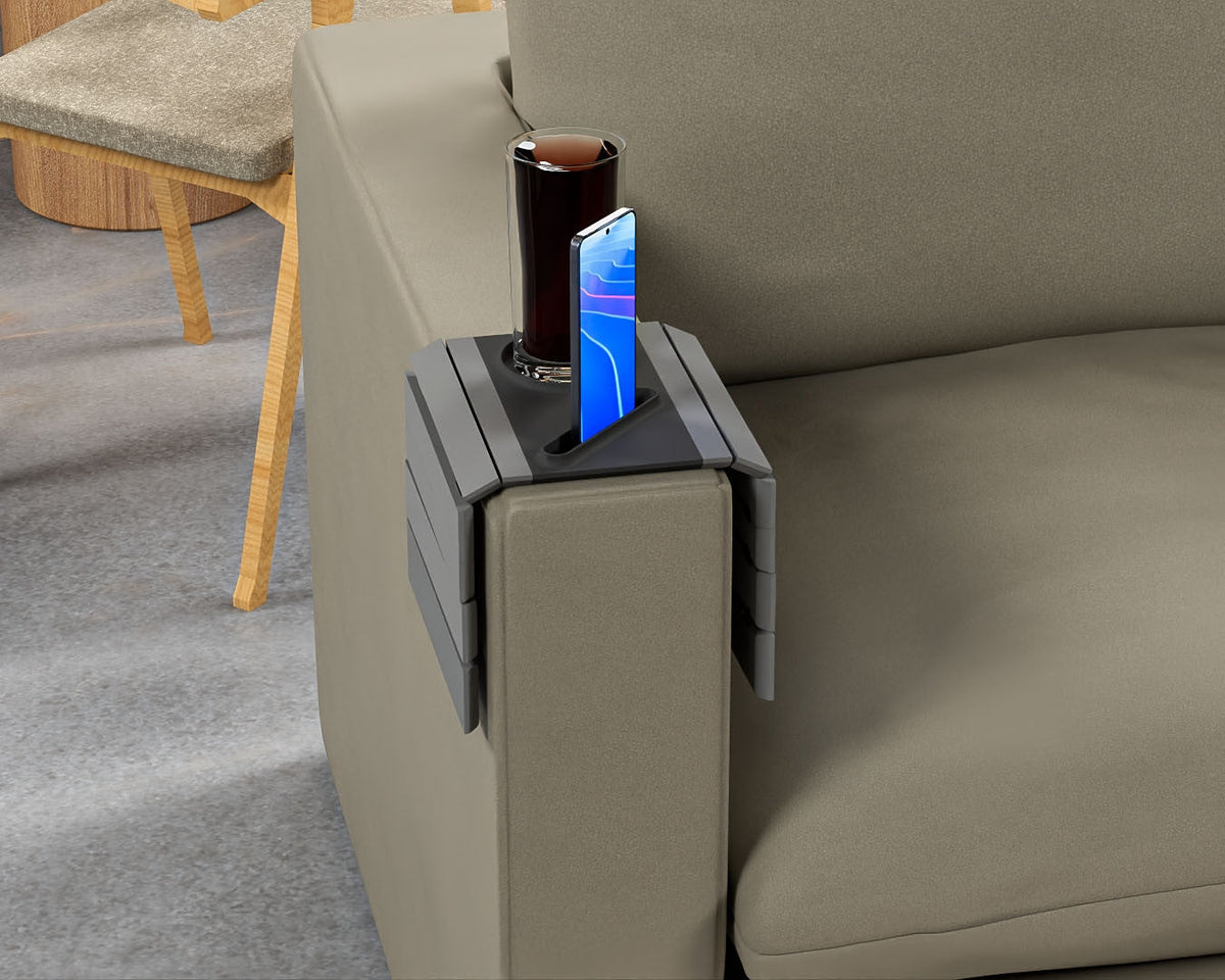 First Stop — Modular Sofa Side Table — the tray on an olive sofa arm with a drink and a phone, a wooden chair behind.