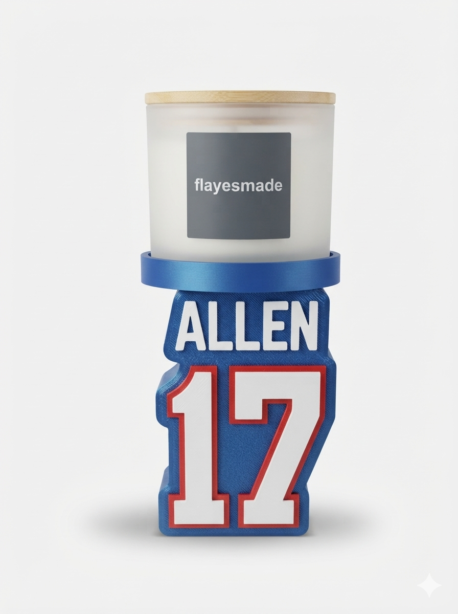 Football Jersey Candle Holder — Buffalo Colors — royal blue jersey-shaped stand with raised white and red lettering and numbering, topped with a blue collar ring holding a lidded frosted-white jar candle, on a soft light-gray studio background.