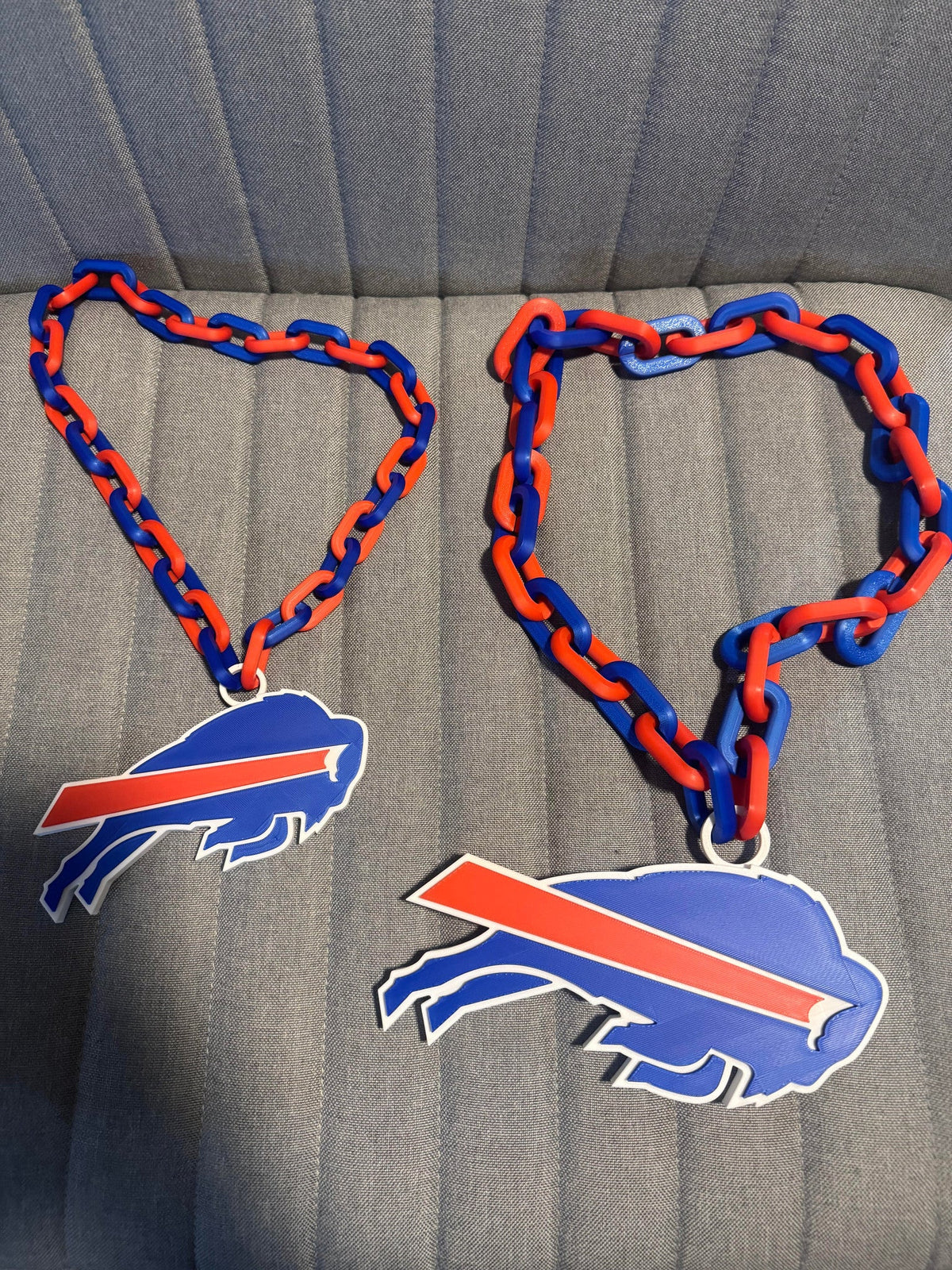 Giant Buffalo Football Necklace — two of the necklaces side by side, showing the chain length and pendant scale.
