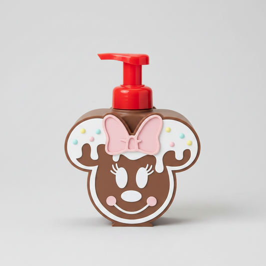 Gingerbread Cookie Bow Soap Dispenser Holder — a mouse-shaped pump bottle with a red pump dispenser, featuring a face design with a pink bow and decorative accents, on a soft light-gray studio background.