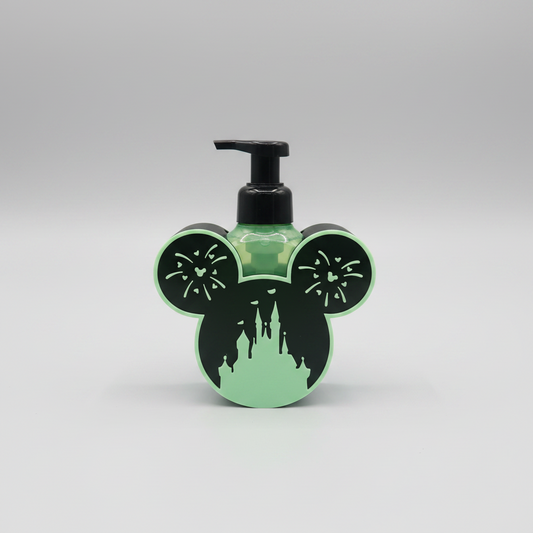 Glow-in-the-Dark Castle Soap Dispenser Holder — a green and black rounded holder with two ear shapes and cut-out detailing, on a soft light-gray studio background.