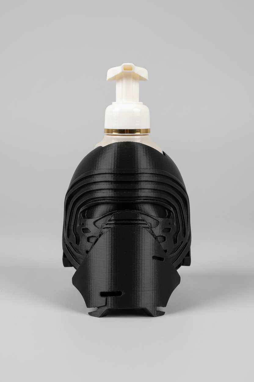 Masked Knight Soap Dispenser Holder — a black helmet-shaped holder styled like a dark knight or warrior, with a white and yellow foam soap dispenser mounted on top, on a soft light-gray studio background.