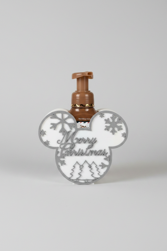 Merry Christmas Soap Dispenser Holder — a holiday soap dispenser shaped like a mouse-head silhouette, featuring a brown pump bottle and "Merry Christmas" script, on a soft light-gray studio background.