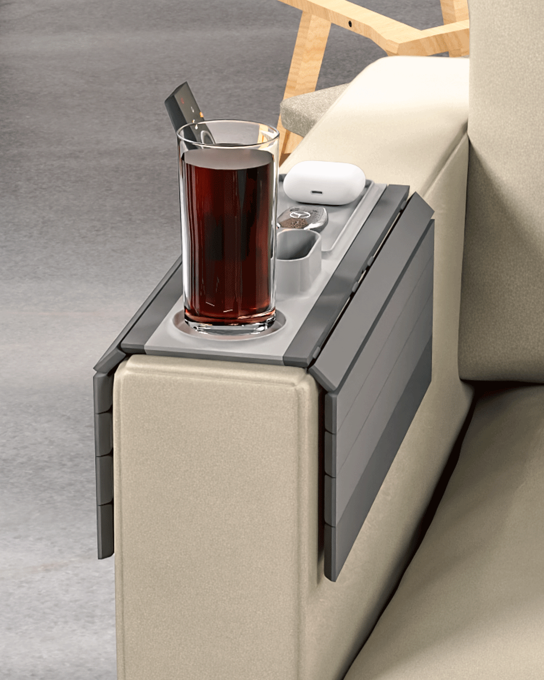 Prime Time Modular Sofa Side Table — the tray draped over a cream sofa arm holding a drink, a remote, earbuds and a phone.