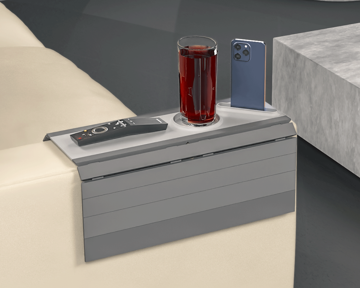 Prime Time Modular Sofa Side Table — the grey tray on a light sofa arm holding a drink, a phone and a remote.