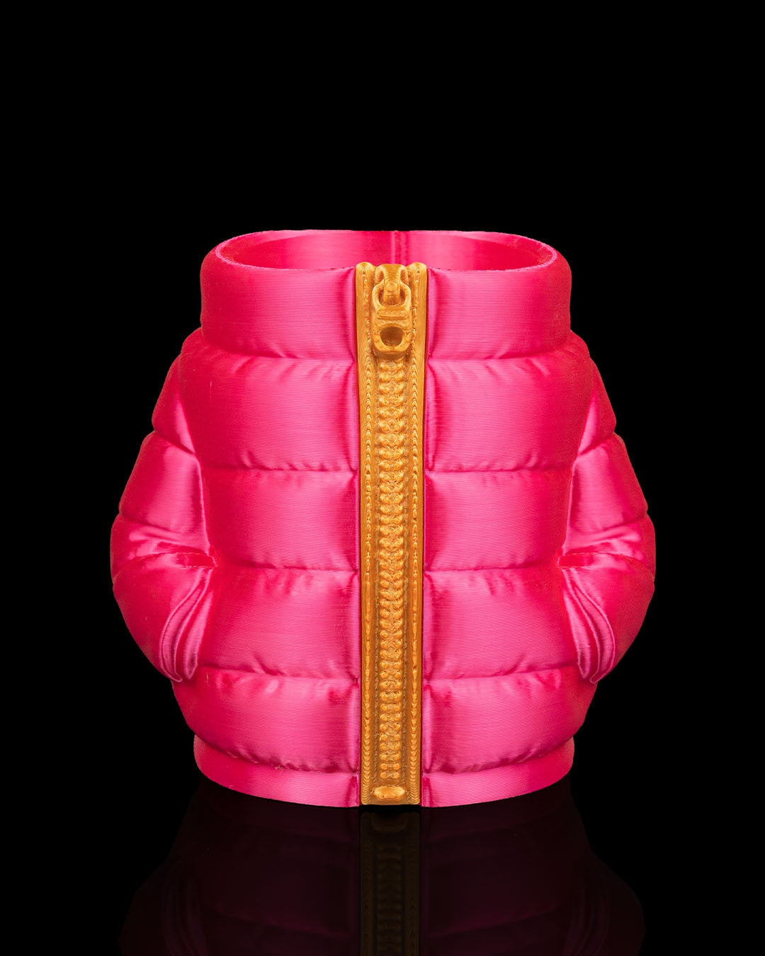 Puffer Jacket Can Holder in pink — a hot pink quilted puffer can sleeve with a gold zipper and side pockets.