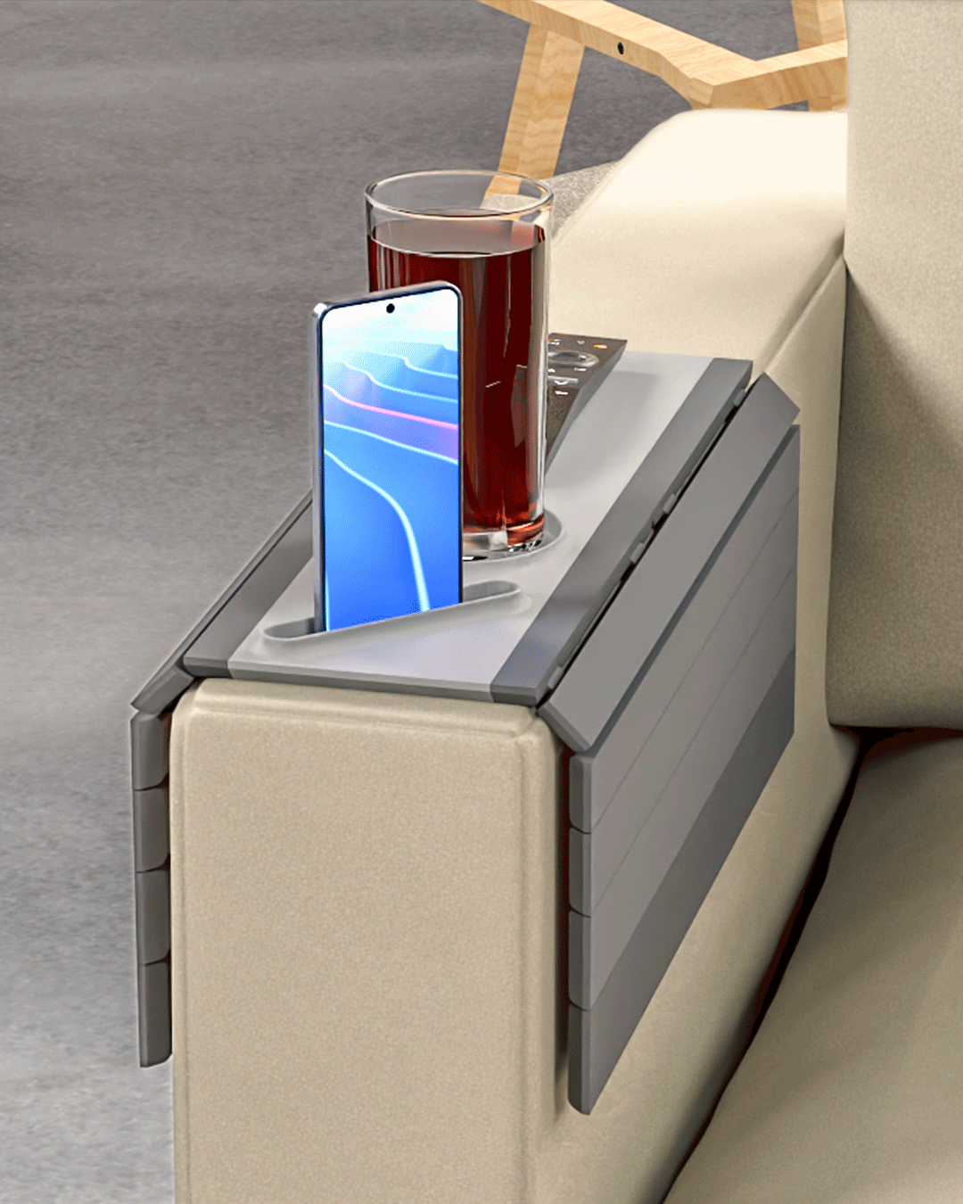 Quick Rest Modular Sofa Side Table — the tray draped over a sofa arm holding a drink, a phone and a remote.