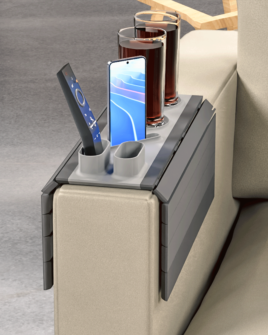 Show Time Modular Sofa Side Table — the tray on a cream sofa arm holding two drinks, a phone in its stand and a remote.