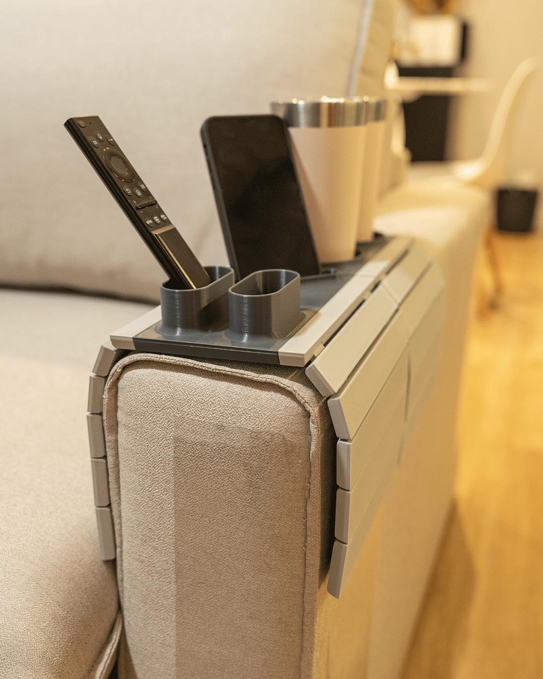 Show Time Modular Sofa Side Table — the tray folded over a sofa arm with two empty cup holders, a phone slot and a remote.
