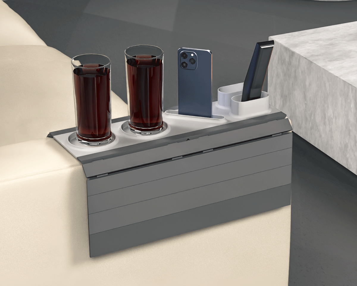 Show Time Modular Sofa Side Table — the grey tray on a light sofa arm holding two drinks, a phone and a remote.