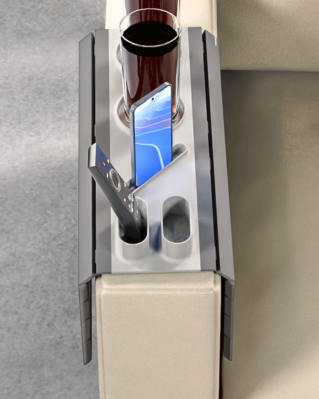 Show Time Modular Sofa Side Table — overhead view of the tray showing two cup holders, a phone slot with a phone, and a remote slot.