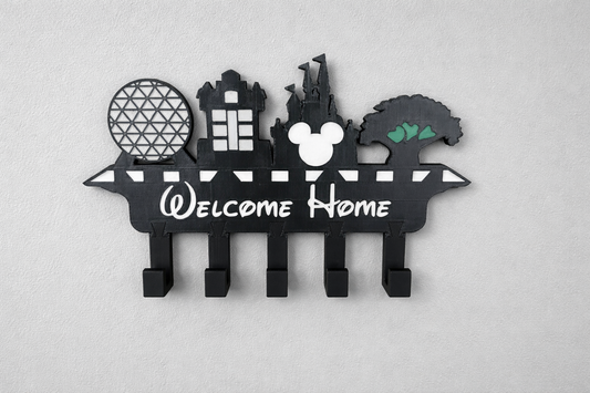 Welcome Home Key Holder — a black wall-mounted key rack with five hooks and a cut-out skyline above 'Welcome Home' lettering.